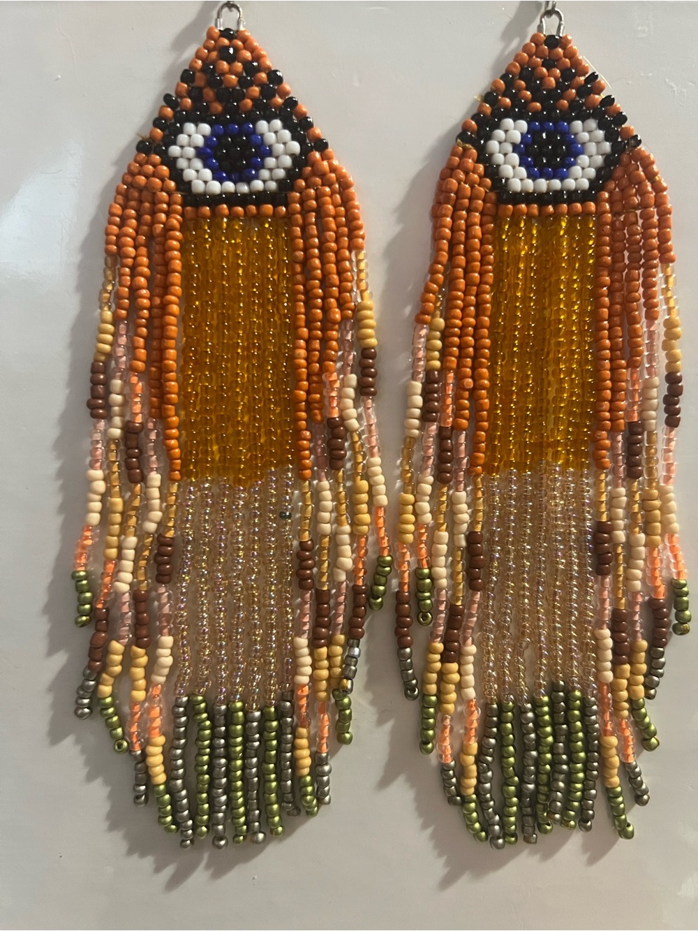 Handmade Orange Fringe Beaded Earrings with Blue Eye Accent
